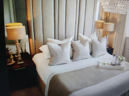 a bedroom with a bed with white pillows at Hotel Abhinandan in Manāli