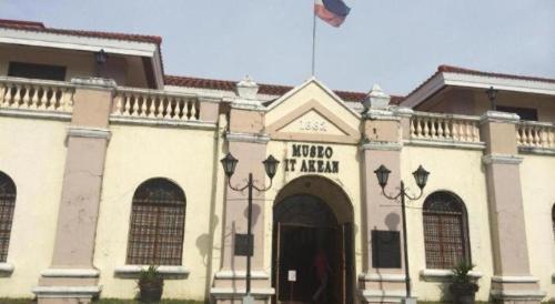 a building with a flag on top of it at The Premiere Business Hotel in Kalibo
