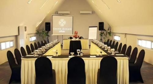 a large meeting room with a long table with chairs at Grand Darmo Suite by AMITHYA in Surabaya