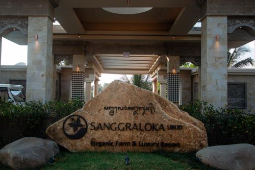 a large rock in front of a building at Sanggraloka Ubud in Ubud