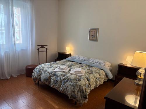a bedroom with a bed with a comforter on it at Livorno Life in Livorno
