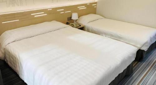 Ένα ή περισσότερα κρεβάτια σε δωμάτιο στο West Hotel