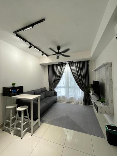 a living room with a couch and a table at Little Haven - Cozy 2BR with Big Swimming Pool in Kajang