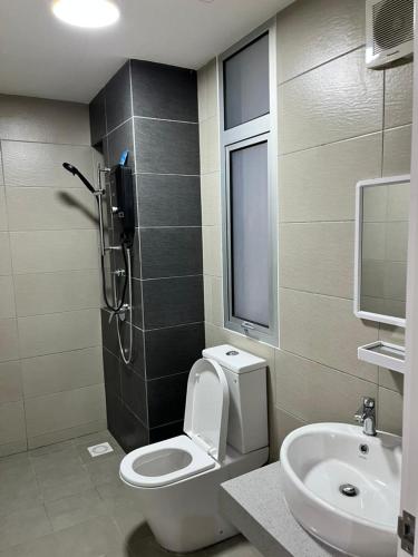 a bathroom with a shower and a toilet and a sink at Little Haven - Cozy 2BR with Big Swimming Pool in Kajang