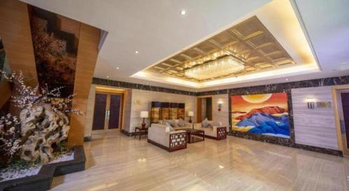 a hotel lobby with a large painting on the wall at Jin Jiang Nanjing Hotel in Nanjing
