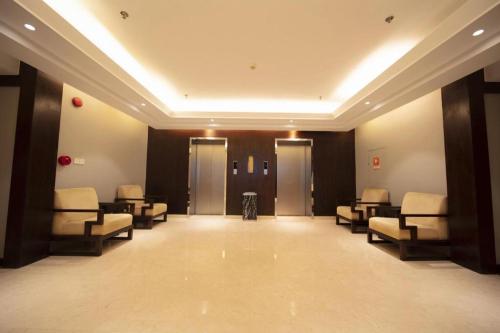a waiting room with chairs and elevators in a building at Jin Jiang Nanjing Hotel in Nanjing