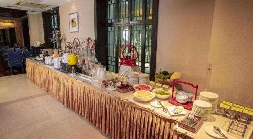 a buffet table with food on it in a room at Jin Jiang Nanjing Hotel in Nanjing