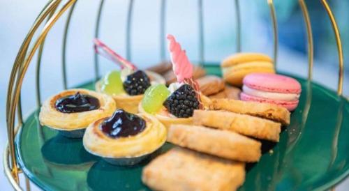 a plate of pastries and cookies on a glass plate at Jin Jiang Nanjing Hotel in Nanjing
