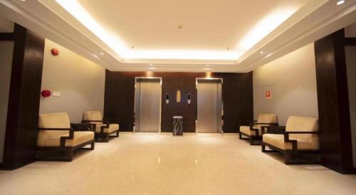a hospital room with chairs and a waiting room with doors at Jin Jiang Nanjing Hotel in Nanjing