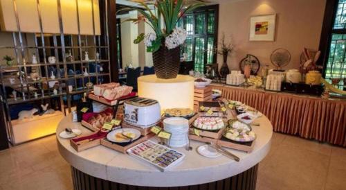 a dessert counter in a store with food on it at Jin Jiang Nanjing Hotel in Nanjing