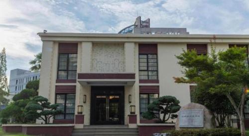 a white building with a sign in front of it at Jin Jiang Nanjing Hotel in Nanjing