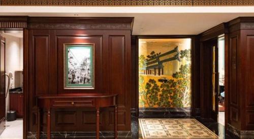 a room with a desk and a painting on the wall at Jin Jiang Nanjing Hotel in Nanjing