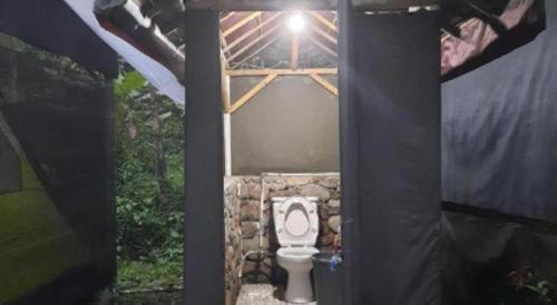 a bathroom with a toilet in a building at Herman Lantang Camp in Bogor