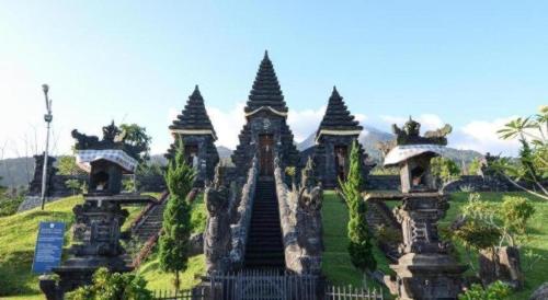 a building with many towers on a grass field at Herman Lantang Camp in Bogor