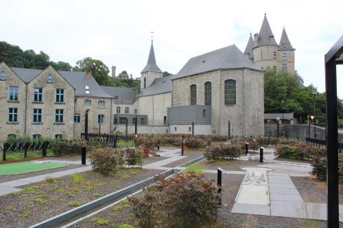 a large building with a garden in front of it at Bos Chalet Durbuy in Durbuy