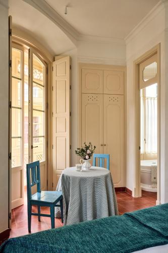 a dining room with a table and two chairs at Cristine Bedfor Malaga Boutique Hotel in Málaga