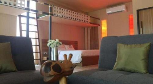 a room with a stuffed animal sitting on a couch at Red Z The Ocean in Phetchaburi