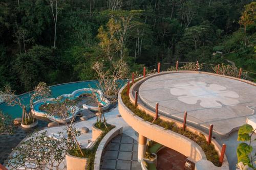 an overhead view of a pool with a table and some plants at Sanggraloka Ubud in Ubud