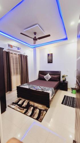 a bedroom with a bed and a blue ceiling at Awesome 3bhk apartment in Hyderabad