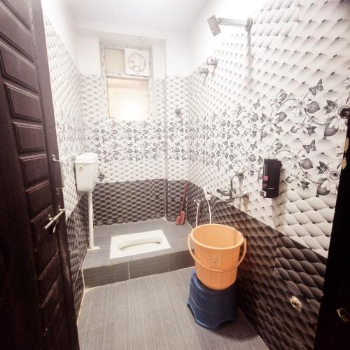 a bathroom with a toilet in the corner at Awesome 3bhk apartment in Hyderabad