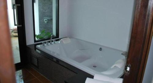 a bathroom with a large white bath tub at Ocean Breeze Residence in Khao Lak