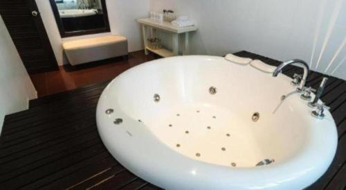 a large white bath tub in a bathroom at Ocean Breeze Residence in Khao Lak