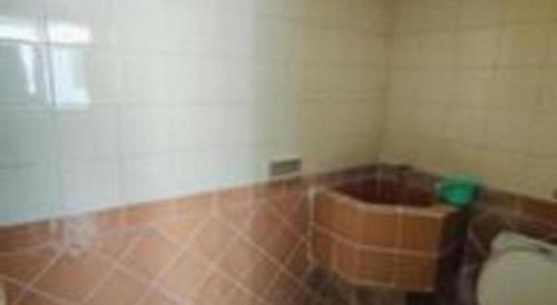 a bathroom with a toilet in a room at Alexander Hotel Tegal in Tegal