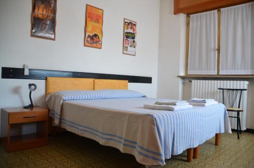 Postel nebo postele na pokoji v ubytování Albergo Roma