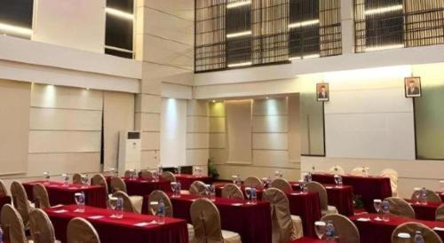 a room with tables and chairs with red table cloth at The BCC Hotel & Residence in Nagoya