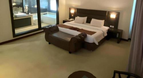 a bedroom with a large bed and a couch at The BCC Hotel & Residence in Nagoya