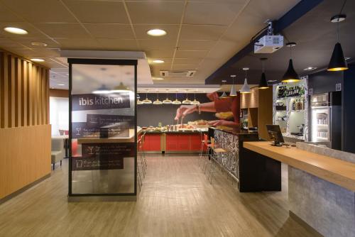 a fast food restaurant with a person preparing food at ibis Aracaju in Aracaju