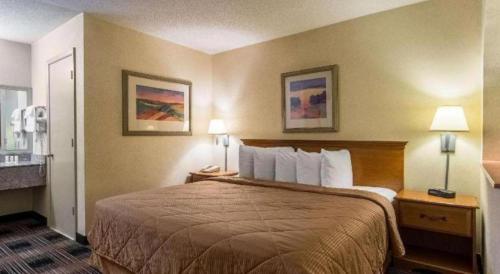 a hotel room with a large bed with two lamps at Quality Inn in Oakwood