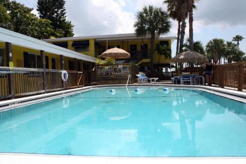 a large blue swimming pool in front of a hotel at Barefoot Bay Resort Motel in Clearwater Beach