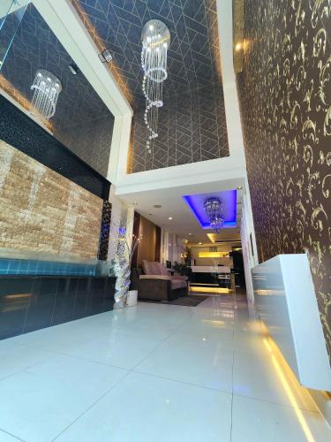 a lobby of a hotel with a chandelier at Masters Suites Hotel in Makkasan