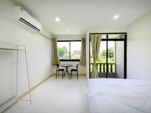 a bedroom with a bed and a table and chairs at Townhouse, 500m the Pink Line MRT, Near Airport 