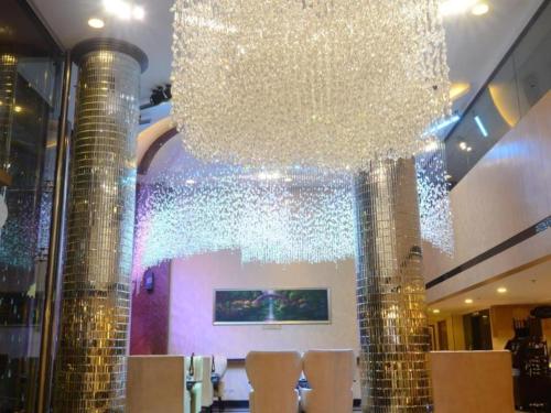 a large chandelier hanging over a table in a restaurant at Le Monet Hotel in Baguio