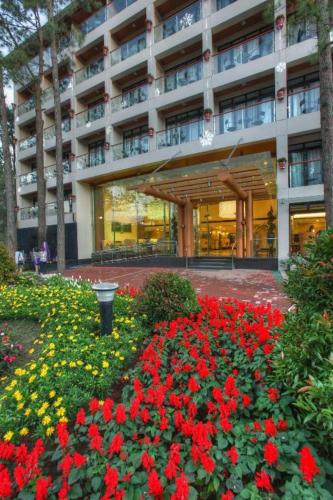 a large building with red flowers in front of it at Le Monet Hotel in Baguio