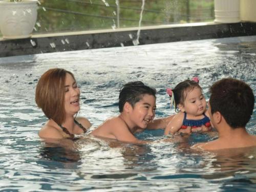 a group of people in a swimming pool at Le Monet Hotel in Baguio