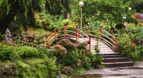 a stairway with a red bridge in a park at Le Monet Hotel in Baguio