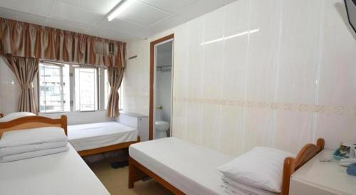 Кровать или кровати в номере New Mong Kok Guest House