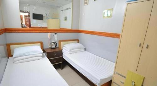 Кровать или кровати в номере New Mong Kok Guest House