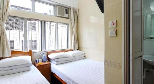Кровать или кровати в номере New Mong Kok Guest House