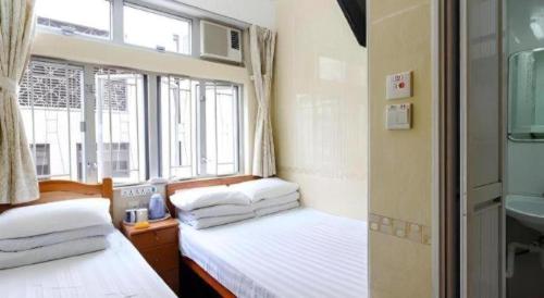 Кровать или кровати в номере New Mong Kok Guest House
