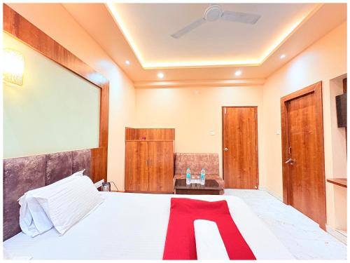 a bedroom with a bed and a large mirror at Hotel Ruby House Near Jagannath Temple in Puri