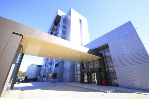 a large building with awning in front of it at Centurion Hotel Technoport Fukui- Artificial Radium Hot Spring in Sakai