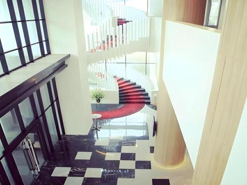 a view of a stairway with escalators and a lobby at Brits Hotel Karawang in Karawang