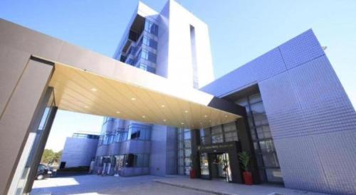 a large building with awning in front of it at Centurion Hotel Technoport Fukui- Artificial Radium Hot Spring in Sakai