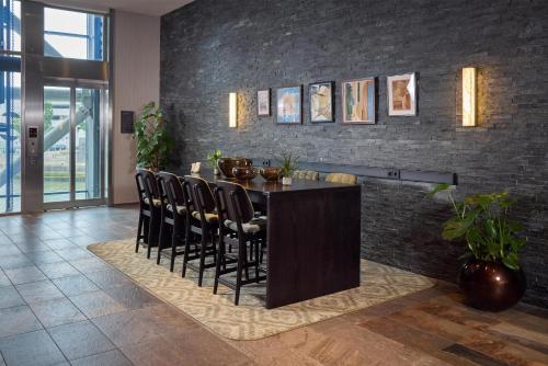 a dining room with a table and chairs at Haven Hotel Rotterdam, Curio Collection by Hilton in Rotterdam