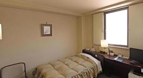 Ένα ή περισσότερα κρεβάτια σε δωμάτιο στο Ueda Plaza Hotel
