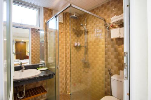 a bathroom with a shower and a sink and a toilet at DMZ Hotel ,Central Hue ,Near Perfume River in Hue